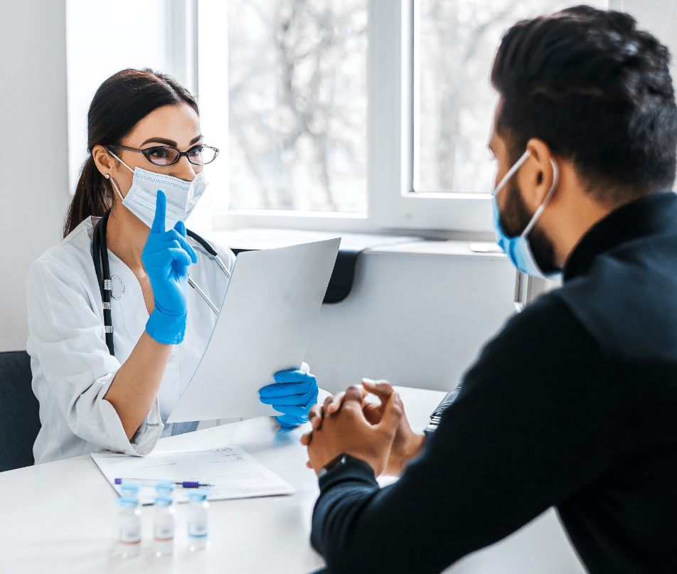 A bizhealth physician pointing out to an emplooyee during a skin check