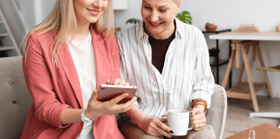 A bizhealth general practitioner giving skin advice to an employee on a tablet