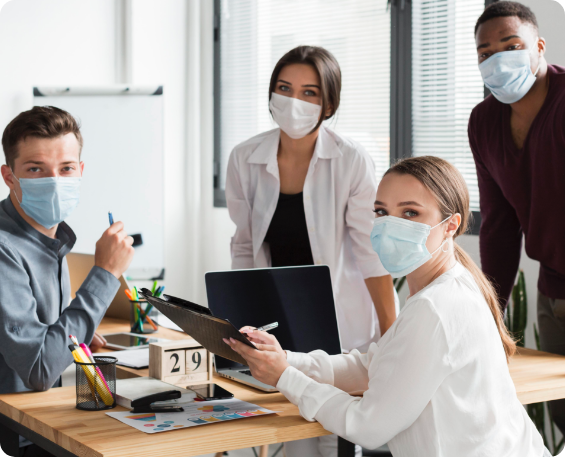 a bizhealth consultant showing her paper board to workplace employees at her desk